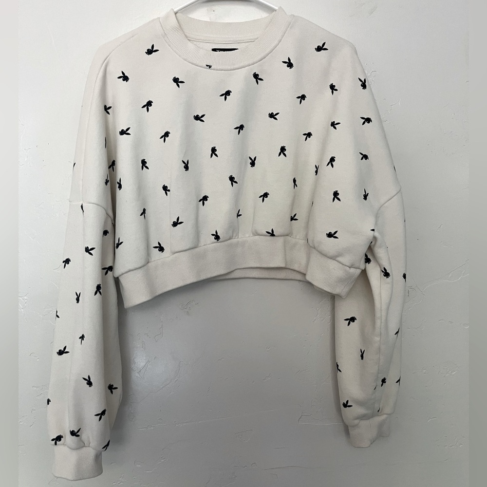 Cropped top sweater size small. It is white with the playboy bunny in black.